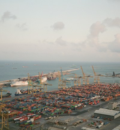 An aerial view of a bustling port with various cargo ships.